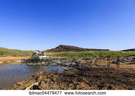 SUV crossing water, Huab riverbed, Damaraland, Kunene Region, Namibia, Africa View Large Photo Image Stock Photo - SUV crossing water, Huab riverbed, Damaraland, Kunene Region, Namibia, Africa. Fotosearch