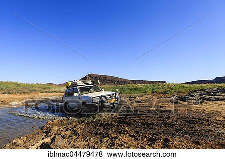SUV crossing water, Huab riverbed, Damaraland, Kunene Region, Namibia, Africa View Large Photo Image Stock Photo - SUV crossing water, Huab riverbed, Damaraland, Kunene Region, Namibia, Africa. Fotosearch