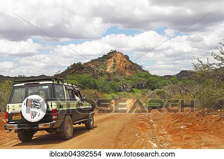 Picture - SUV in Tsavo West National Park, Taita-Taveta County, Kenya, Africa. Fotosearch