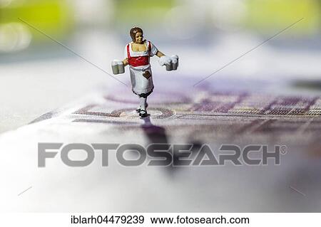 Stock Photo - Symbolic photo of hospitality, waitress, miniature figure on 500 Euro note. Fotosearch