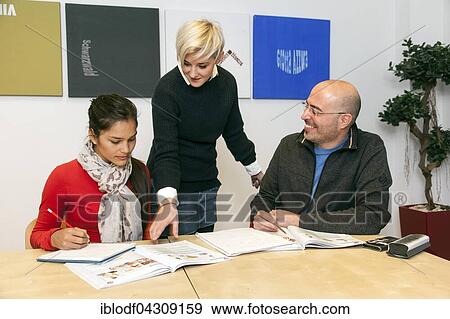 Teacher shows student something in a book, German course at a language school, Düsseldorf, North Rhine-Westphalia, Germany, Europe View Large Photo Image Stock Photo - Teacher shows student something in a book, German course at a language school, Düsseldorf, North Rhine-Westphalia, Germany, Europe. Fotosearch