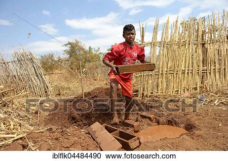 Teenager manufacturing bricks, Analakely village, Tanambao commune, Tsiroanomandidy district, Bongolava region, Madagascar, Africa View Large Photo Image Stock Image - Teenager manufacturing bricks, Analakely village, Tanambao commune, Tsiroanomandidy district, Bongolava region, Madagascar, Africa. Fotosearch