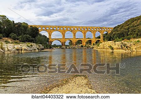 The Pont du Gard Roman aqueduct, over the Gardon River, Languedoc-Roussillon, South of France View Large Photo Image Stock Image - The Pont du Gard Roman aqueduct, over the Gardon River, Languedoc-Roussillon, South of France. Fotosearch