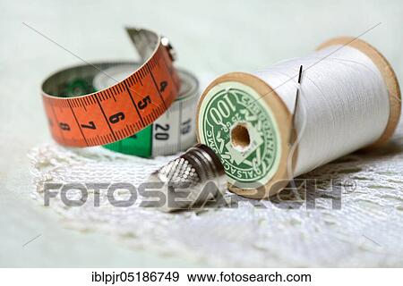 Thread roll with sewing needle, thimble and tape measure View Large Photo Image Stock Photo - Thread roll with sewing needle, thimble and tape measure. Fotosearch