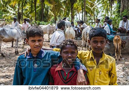 Three local boys posing with arms around one another, local scene, Tamil Nadu, India, Asia View Large Photo Image Stock Photo - Three local boys posing with arms around one another, local scene, Tamil Nadu, India, Asia. Fotosearch