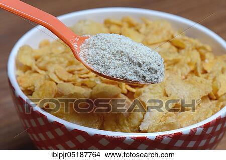 Picture - Tigernut flour in spoon and cornflakes in shell, Cyperus esculentus. Fotosearch