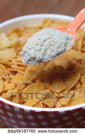 Stock Photography - Tigernut flour in spoon and cornflakes in shell, Cyperus esculentus. Fotosearch