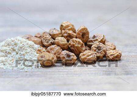 Stock Image - Tigernuts and tigernut flour, Cyperus esculentus. Fotosearch