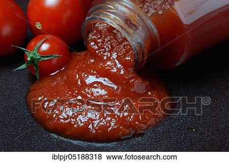 Stock Photo - Tomato ketchup flows from bottle. Fotosearch