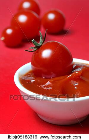 Stock Photograph - Tomato ketchup in shell and tomatoes. Fotosearch