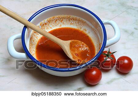 Tomato soup in a bowl with cooking spoon and tomatoes, Solanum lycopersicum View Large Photo Image Stock Image - Tomato soup in a bowl with cooking spoon and tomatoes, Solanum lycopersicum. Fotosearch