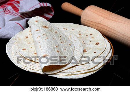 Stock Image - Tortillas on plate and rolling pin, wrap, wraps, mexican, mexican. Fotosearch