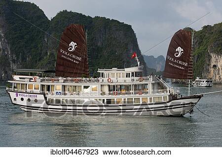 Tourist boat, junk boat between limestone cliffs, Halong Bay, Gulf of Tonkin, North Vietnam, Vietnam, Asia View Large Photo Image Stock Image - Tourist boat, junk boat between limestone cliffs, Halong Bay, Gulf of Tonkin, North Vietnam, Vietnam, Asia. Fotosearch