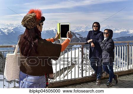 Stock Image - Tourists, Asian making photos with tablet, view from Pilatus, Lucerne, Switzerland, Europe. Fotosearch