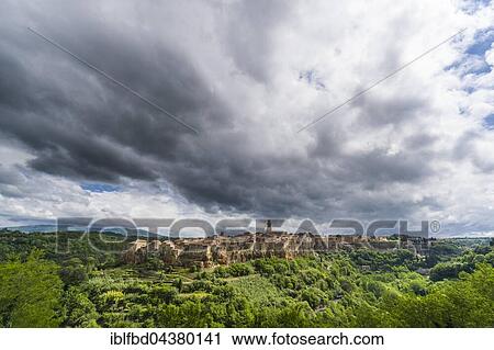 Town on hill and cloudy sky, Pitigliano, Tuscany, Italy, Europe View Large Photo Image Stock Image - Town on hill and cloudy sky, Pitigliano, Tuscany, Italy, Europe. Fotosearch
