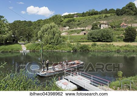 Traditional reaction ferry on the river Saale, rope drawn by the ferryman, vineyards behind, Naumburg, Saxony-Anhalt, Germany, Europe View Large Photo Image Stock Image - Traditional reaction ferry on the river Saale, rope drawn by the ferryman, vineyards behind, Naumburg, Saxony-Anhalt, Germany, Europe. Fotosearch