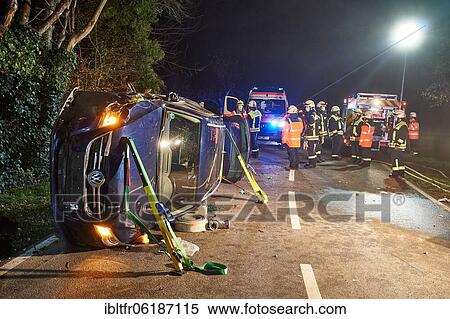 Traffic accident, car lying on its side, fire brigade and ambulance on the scene, Rhineland-Palatinate, Germany, Europe View Large Photo Image Stock Photography - Traffic accident, car lying on its side, fire brigade and ambulance on the scene, Rhineland-Palatinate, Germany, Europe. Fotosearch