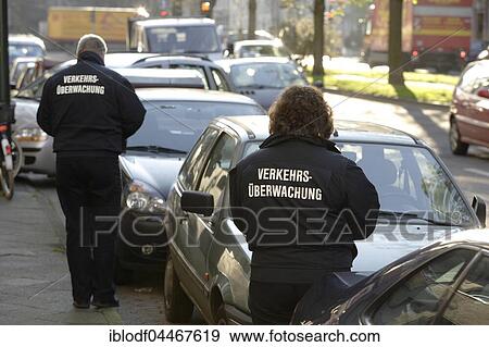 Stock Photo - Traffic monitoring, traffic wardens distribute traffic tickets to parking offenders, Düsseldorf, North Rhine-Westphalia, Germany, Europe. Fotosearch