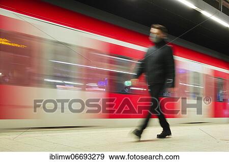Travellers with a face mask, waiting for an incoming S-Bahn, corona crisis, main station, Stuttgart, Baden-Württemberg, Germany, Europe View Large Photo Image Stock Photo - Travellers with a face mask, waiting for an incoming S-Bahn, corona crisis, main station, Stuttgart, Baden-Württemberg, Germany, Europe. Fotosearch