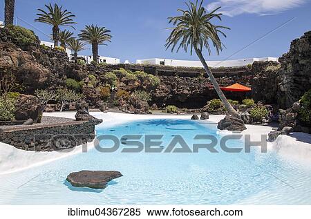 Tropical garden with swimming pool, lava cave Jameos del Agua, by Cesar Manrique, Lanzarote, Canary Islands, Spain, Europe View Large Photo Image Stock Photography - Tropical garden with swimming pool, lava cave Jameos del Agua, by Cesar Manrique, Lanzarote, Canary Islands, Spain, Europe. Fotosearch
