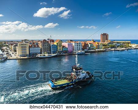Tugboat, colorful row of houses in Punda district at back, commercial arcade, waterfront, World Heritage Site, Willemstad, Lesser Antilles, Curacao, South America View Large Photo Image Stock Image - Tugboat, colorful row of houses in Punda district at back, commercial arcade, waterfront, World Heritage Site, Willemstad, Lesser Antilles, Curacao, South America. Fotosearch