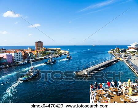 Tugboat, colorful row of houses in Punda district at back, commercial arcade, waterfront, World Heritage Site, Willemstad, Lesser Antilles, Curacao, South America View Large Photo Image Stock Photo - Tugboat, colorful row of houses in Punda district at back, commercial arcade, waterfront, World Heritage Site, Willemstad, Lesser Antilles, Curacao, South America. Fotosearch