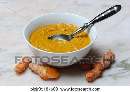 Stock Photo - Turmeric paste in shell and turmeric root, turmeric longa, turmeric root, turmeric paste. Fotosearch