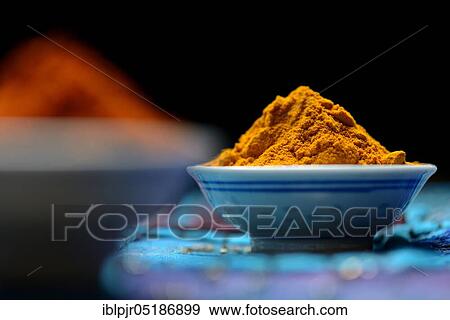 Stock Photo - Turmericpowder ( Curcuma longa) in bowl. Fotosearch