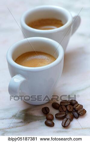 Two cups of espresso and coffee beans View Large Photo Image Stock Image - Two cups of espresso and coffee beans. Fotosearch