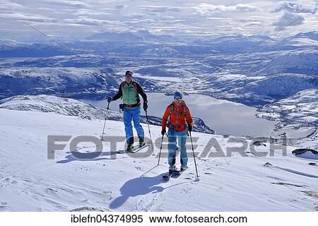 Two ski tourers ascending Skarelvfjellet, snowy mountain landscape with lakes, Senja, Norway, Europe View Large Photo Image Stock Photography - Two ski tourers ascending Skarelvfjellet, snowy mountain landscape with lakes, Senja, Norway, Europe. Fotosearch