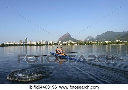 Two young women participating in early morning rowing training in the Lagoa Rodrigo de Freitas Lagoon, with Rio de Janeiro skyline and Sugar Loaf Mountain, Lagoa District, Rio de Janeiro, Brazil, South America View Large Photo Image Stock Photograph - Two young women participating in early morning rowing training in the Lagoa Rodrigo de Freitas Lagoon, with Rio de Janeiro skyline and Sugar Loaf Mountain, Lagoa District, Rio de Janeiro, Brazil, South America. Fotosearch