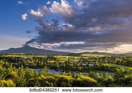Typical green Tuscan landscape in Val d’Orcia with hills, a lake, trees, yellow broom bushes and Monte Amiata in the distance, Spedaletto, Tuscany, Italy, Europe View Large Photo Image Stock Image - Typical green Tuscan landscape in Val d’Orcia with hills, a lake, trees, yellow broom bushes and Monte Amiata in the distance, Spedaletto, Tuscany, Italy, Europe. Fotosearch