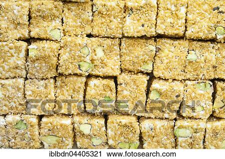Stock Image - Typical Turkish delights with sesame, on display at the Grand Bazaar, Istanbul, Turkey, Asia. Fotosearch