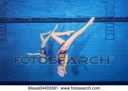Underwater view of Synchronized Swimming in a swimming pool, Ukraine, Europe View Large Photo Image Stock Image - Underwater view of Synchronized Swimming in a swimming pool, Ukraine, Europe. Fotosearch