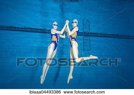 Underwater view of Synchronized Swimming in a swimming pool, Ukraine, Europe View Large Photo Image Stock Photograph - Underwater view of Synchronized Swimming in a swimming pool, Ukraine, Europe. Fotosearch
