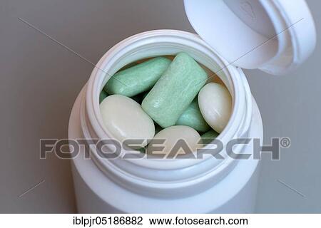 Stock Image - Various chewing gums in containers, chewing gum lozenges, dragees, chewing gum strips. Fotosearch