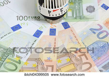 Stock Photography - Various Euro bills and radiator thermostat. Fotosearch