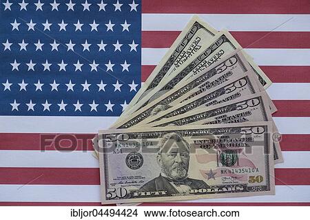 Various US dollar bills on American flag View Large Photo Image Picture - Various US dollar bills on American flag. Fotosearch
