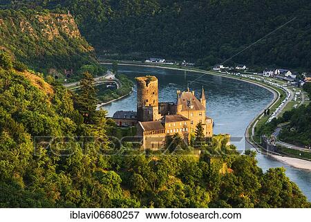 Stock Photo - View of Katz Castle on the Rhine, also Neukatzenelnbogen Castle, in the back the Loreley Rock, evening light, World Heritage Upper Middle Rhine Valley, St. Goarshausen, Rhineland-Palatinate, Germany, Europe. Fotosearch