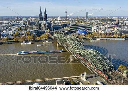View over the river Rhine, Cologne's historic centre, Cargo Ship, Museum Ludwig, Cologne Cathedral, Hohenzollern Bridge, Central Station, Musical Dome, behind Colonius TV tower and KölnTurm, Cologne, North Rhine-Westphalia, Germany, Europe View Large Photo Image Picture - View over the river Rhine, Cologne's historic centre, Cargo Ship, Museum Ludwig, Cologne Cathedral, Hohenzollern Bridge, Central Station, Musical Dome, behind Colonius TV tower and KölnTurm, Cologne, North Rhine-Westphalia, Germany, Europe. Fotosearch