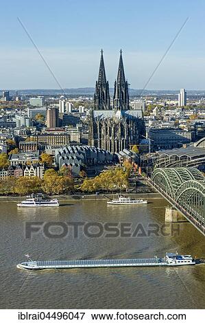 Stock Photo - View over the river Rhine, Cologne's historic centre, Cargo Ship, Museum Ludwig, Cologne Cathedral, Hohenzollern Bridge, Cologne, North Rhine-Westphalia, Germany, Europe. Fotosearch