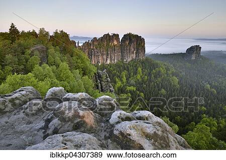 View over the Schrammsteine, fog over the Elbe valley in Bad Schandau, Saxon Switzerland, Elbe Sandstone Mountains, Saxony, Germany, Europe View Large Photo Image Stock Photo - View over the Schrammsteine, fog over the Elbe valley in Bad Schandau, Saxon Switzerland, Elbe Sandstone Mountains, Saxony, Germany, Europe. Fotosearch