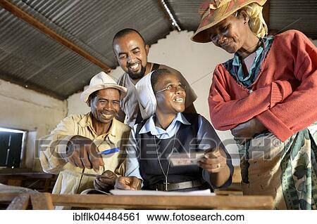 Villagers fill out applications for certification of their land on the village square, Analakely village, Tanambao commune, Tsiroanomandidy district, Bongolava region, Madagascar, Africa View Large Photo Image Stock Image - Villagers fill out applications for certification of their land on the village square, Analakely village, Tanambao commune, Tsiroanomandidy district, Bongolava region, Madagascar, Africa. Fotosearch