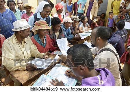 Villagers fill out applications for certification of their land on the village square, Analakely village, Tanambao commune, Tsiroanomandidy district, Bongolava region, Madagascar, Africa View Large Photo Image Stock Photo - Villagers fill out applications for certification of their land on the village square, Analakely village, Tanambao commune, Tsiroanomandidy district, Bongolava region, Madagascar, Africa. Fotosearch