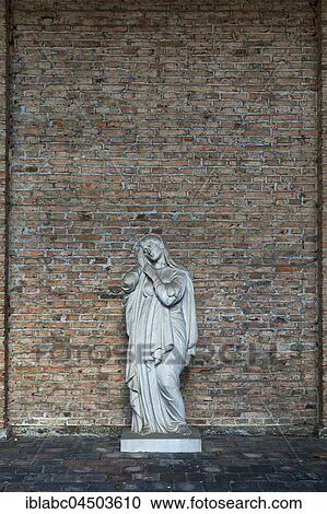 Stock Image - Wall at the Südfriedhof with tomb figure, Munich, Bavaria, Germany, Europe. Fotosearch