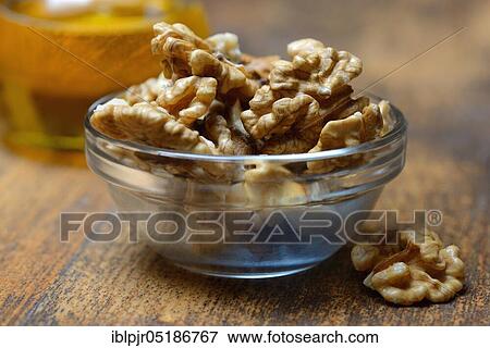 Stock Photo - Walnuts ( Juglans regia) in shell and walnut oil. Fotosearch
