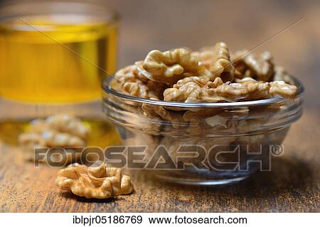 Stock Photo - Walnuts ( Juglans regia) in shell and walnut oil. Fotosearch