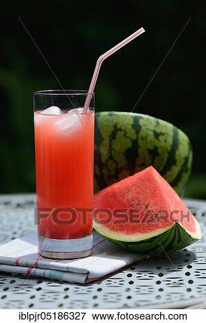 Watermelon juice in glass with drinking straw View Large Photo Image Stock Photo - Watermelon juice in glass with drinking straw. Fotosearch