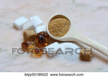 Stock Image - White and brown sugar, beet sugar, cane sugar, candy sugar, sugar cubes, granulated sugar. Fotosearch