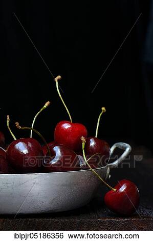 Stock Photograph - Wild cherries (Prunus avium) in a bowl. Fotosearch
